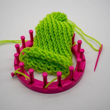 Yuvarlak örgü beyaz arka plan üzerinde izole temel dikiş ile kit ve yeşil iplik dokuma tezgâhı.