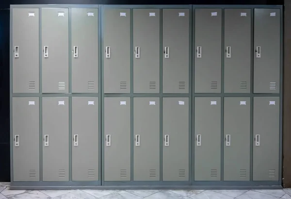 Grey metal cabinets school or gym with  handles and locks in two row