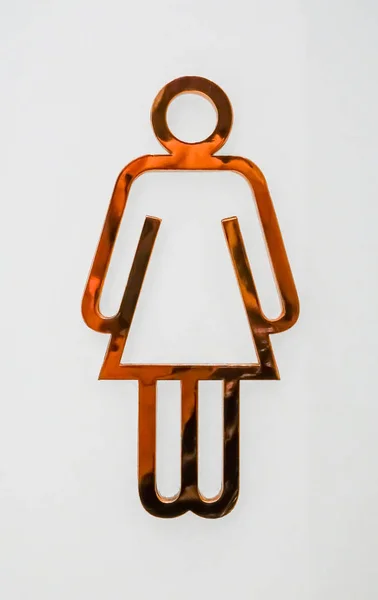 Public restroom signs with female symbol made of copper on white background