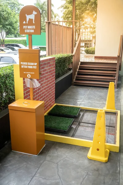 Pet Waste Station in shopping mall or public area. Public trash can for dog waste poop sign. Garbage container of dog pet garbage.