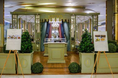 Laduree restaurant at Siam Paragon, Bangkok, Thailand, May 9, 2018 :  French luxury bakery and sweets cafeteria interior in vintage style from entrance view. clipart