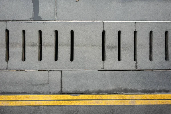 Tampa Drenagem Água Cinza Piso Concreto Com Linhas Amarelas Duplas — Fotografia de Stock