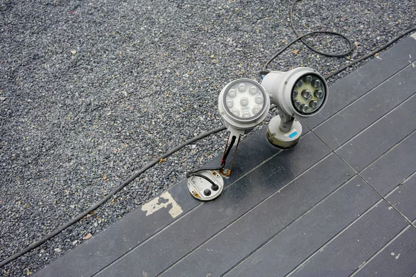 LED spot light install on black wooden ground floor.