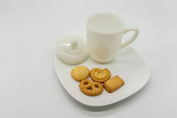 Homemade cookie and tea on ceramic dish isolated on white — Stock Photo, Image