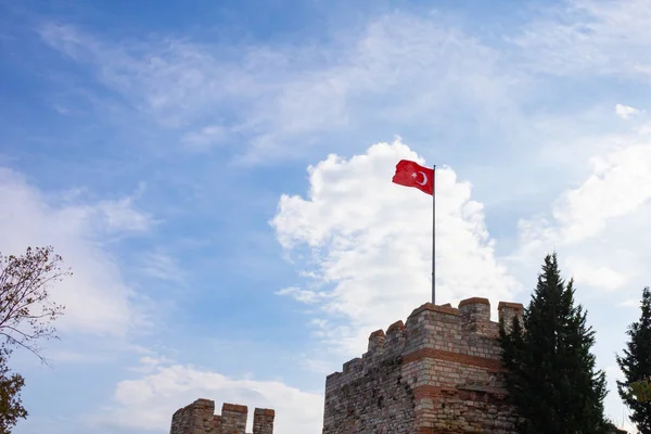Flag of Turkey on the castle with cloudy sky