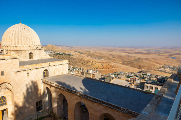 Zinciriye Madrasa with old town of Mardin city at daytime in the summer. Visit Mardin concept photo.