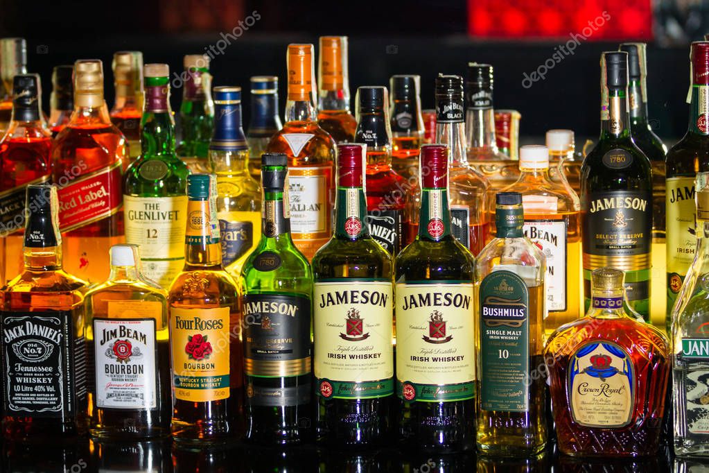 Chisinau, Republic of Moldova - January17, 2016: Several types of bottled alcohol are displayed on some shelves in a pub. Horizontally framed shot.