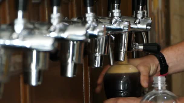 Bartender Pours Dark Beer Plastic Bottle Closes Bottle Lid Puts — Stock Video