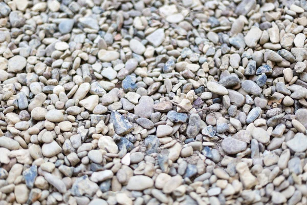 Fondo de piedra de río o mar. Conjunto de todo tipo de piedras. Parte de la imagen está borrosa . — Foto de Stock