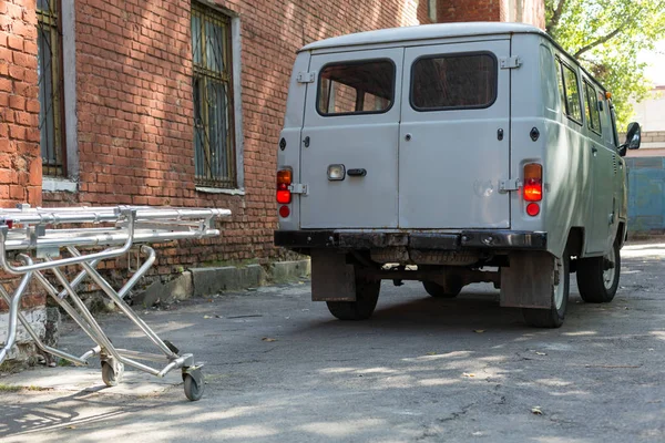 Old ambulance and stretcher gurney bed near by hospital.