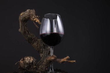 Geleneksel ahşap asma siyah bir arka plan ile kırmızı şarap