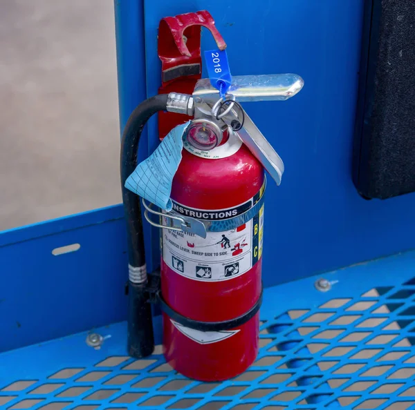 Fire extinguisher on cherry picker — Stock Photo, Image