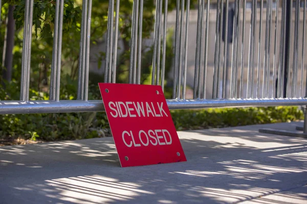 Sidewalk closed sign with copyspace and bars