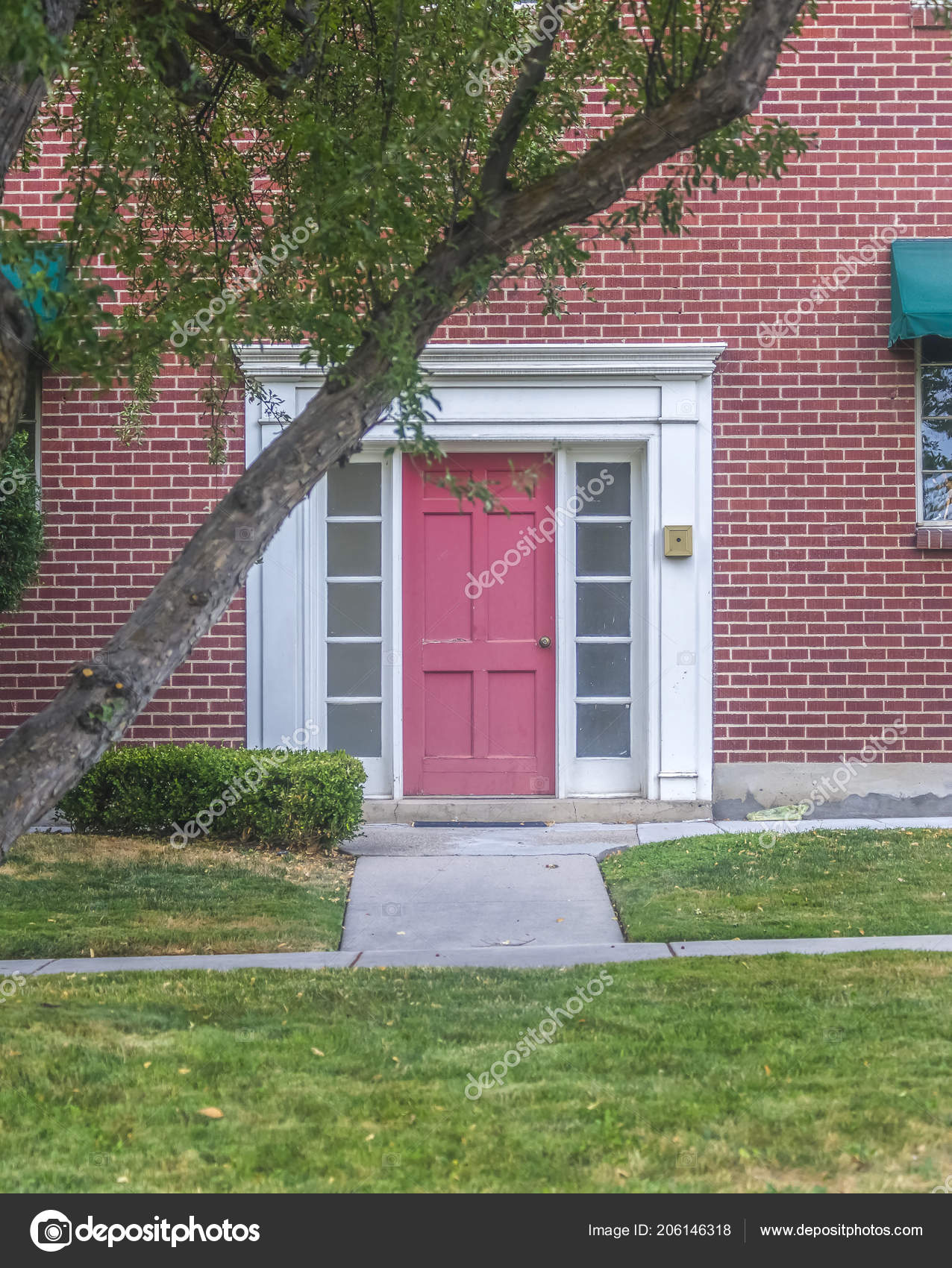 Red Front Door On A Red Brick Building Stock Photo