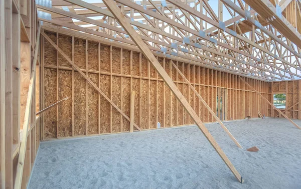 Wooden construction of building in sand pit