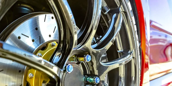 Gepolijste mag wiel met blauwe bout doppen van een auto — Stockfoto