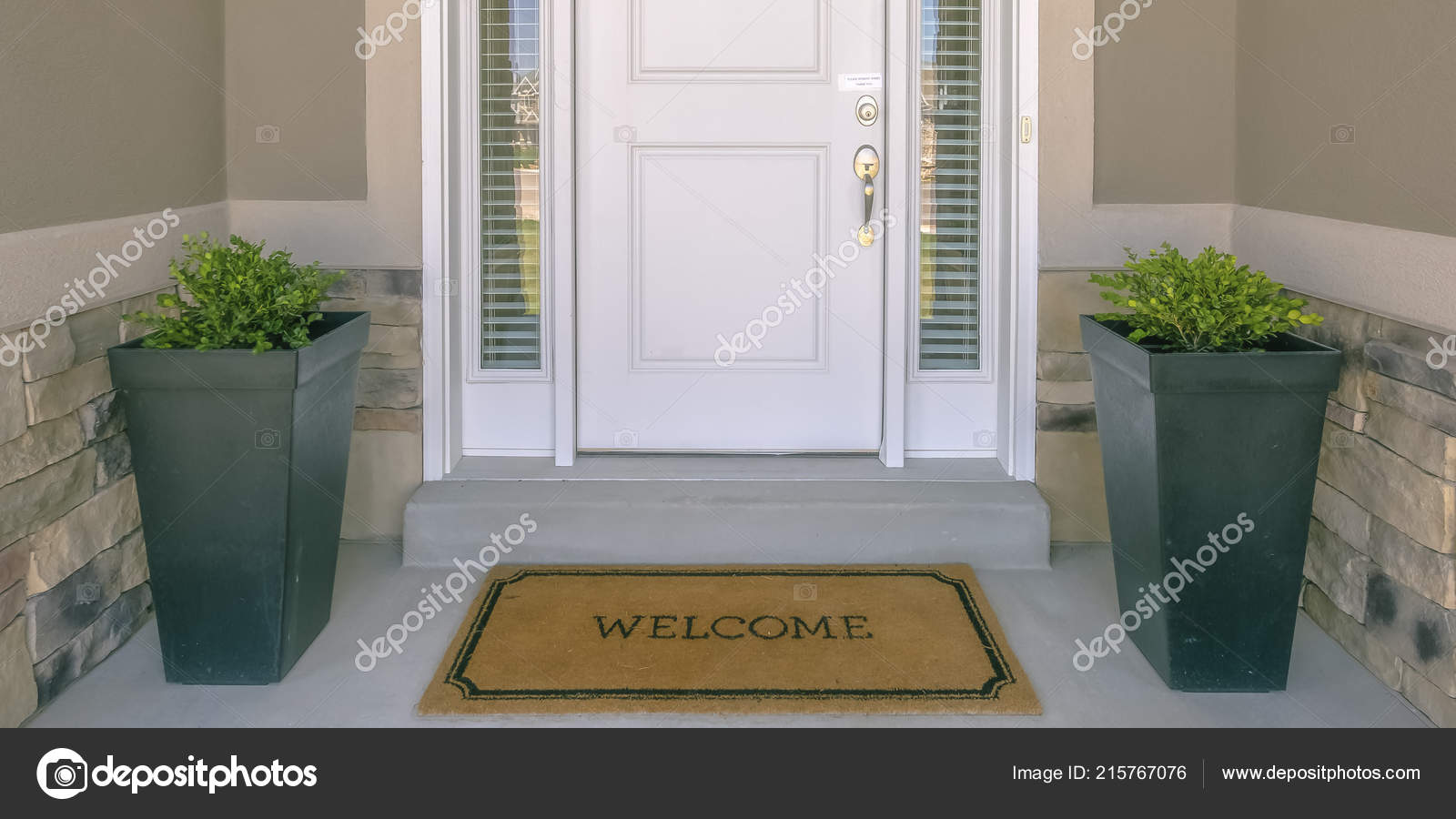 Front door with doormat plants and glass panel Stock Photo by