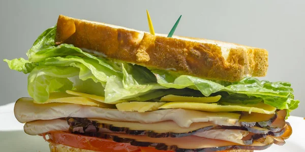 Deli sandwich with toothpicks to secure filling