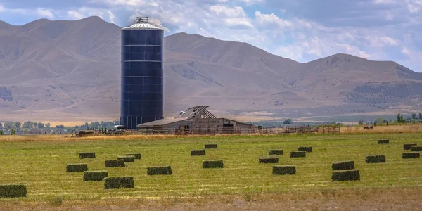 Granero y silo en una granja con pajar en el campo — Foto de Stock