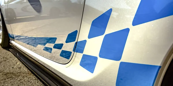 Blue decal on the exterior body of a white car — Stock Photo, Image