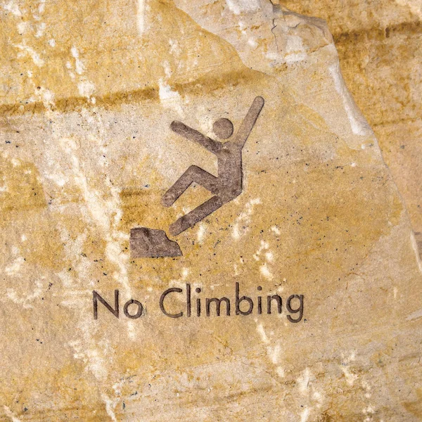 Brown rock engraved with no climbing sign — Stock Photo, Image