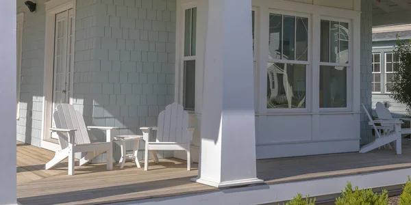 Home with tables and chairs on the sunlit porch — Stock Photo, Image