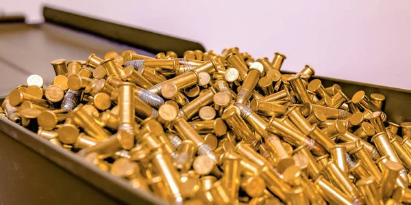 Open container brimming with some golden bullets — Stock Photo, Image