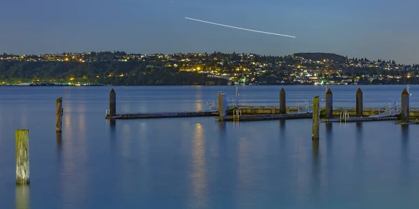 Pilastri in legno a Tacoma con contrail nel cielo — Foto Stock