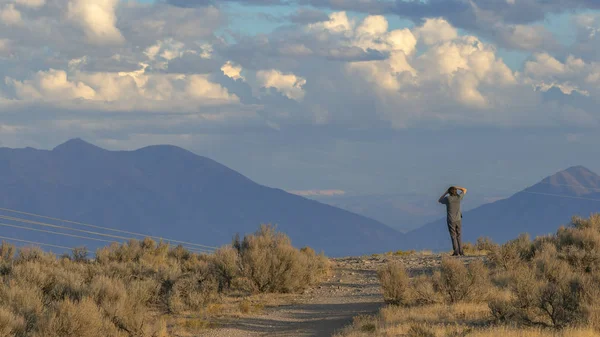 Man on a road overlooking Utah Valley on sunny day