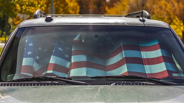 American flag sun shade in car windshield — Stock Photo, Image