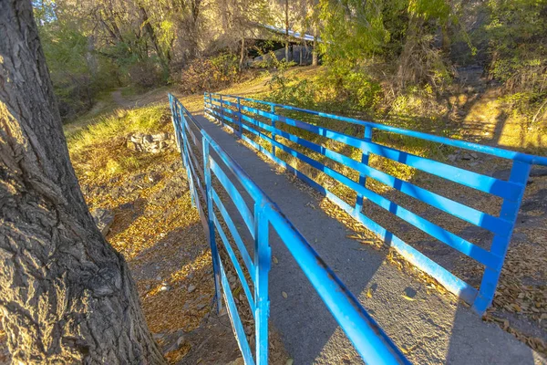 Small bridge over river blue railing off center — Stock Photo, Image