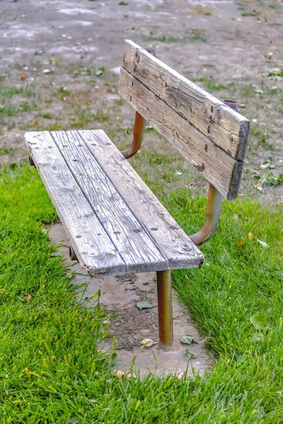 Wooden bench painted white on a grassy terrain