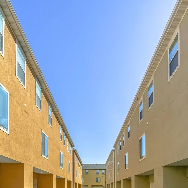 Back view of residential buildings against blue sky
