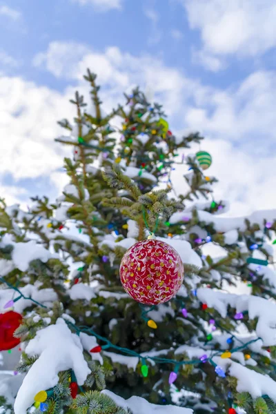 Outdoor Christmas tree against a cloudy blue sky