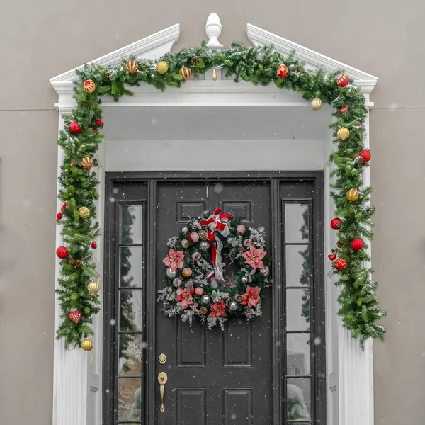 Glass paned front door with garland and wreath