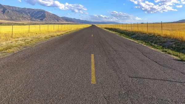 Paved road majestic mountain and sky with clouds