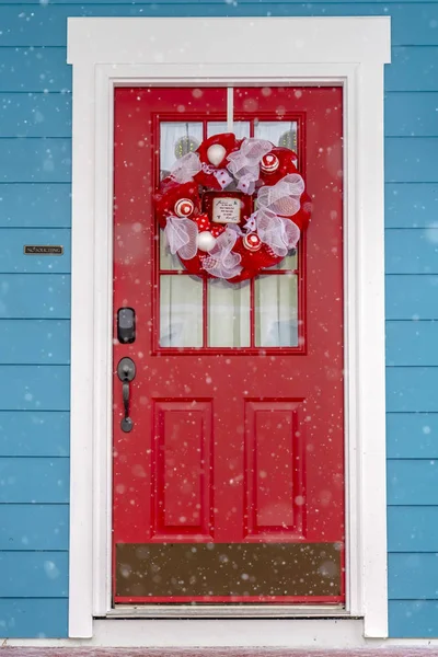 Vibrant red glass paned front door with wreath