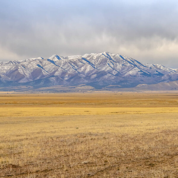 Lowe Peak towering over grassland in Utah Valley