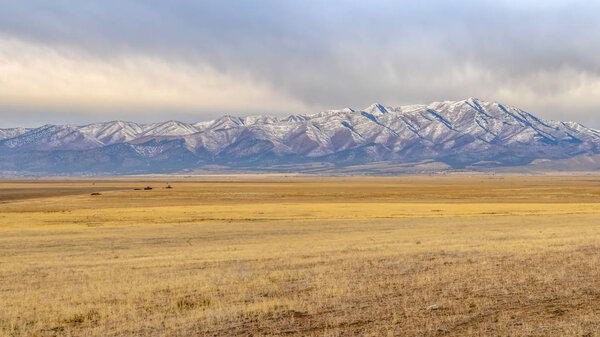 Lowe Peak beyond grassy terrain in Utah Valley