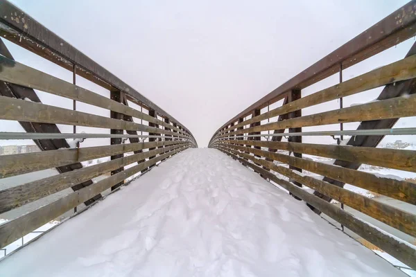 Snowy bridge with footsteps during winter in Utah