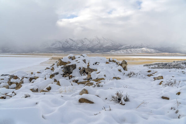 Snowy rocks and snow capped Lowe Peak in Utah