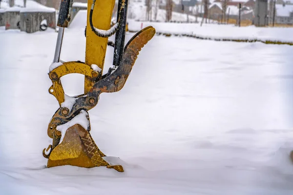 Excavator digging snow on a winter day in Utah