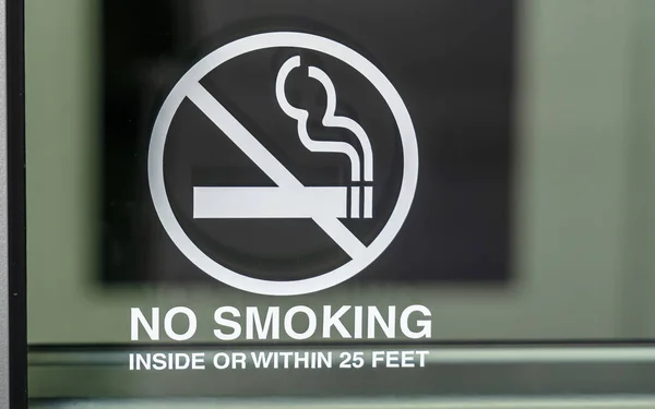 No Smoking sign on a glass surface