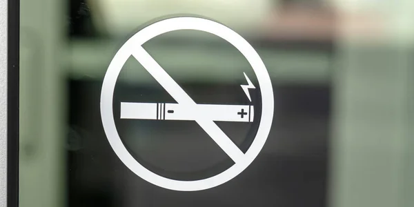 No Smoking sign symbol on a glass surface