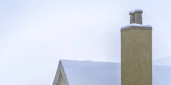 Techo cubierto de nieve y chimenea contra el cielo en Utah — Foto de Stock