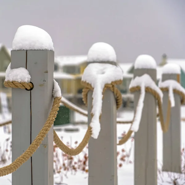 Snowy rope fence against winter landscape in Utah