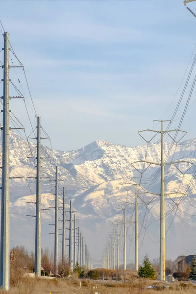 An Electicity posts against snowy Mount Timpanogos