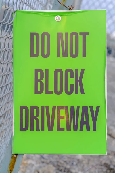 Do Not Block Driveway sign on a mesh wire fence