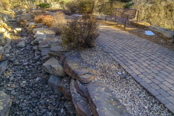 Brick pathway and rocky ground on a park in Provo