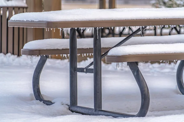Snow covered table with seats in Eagle Mountain